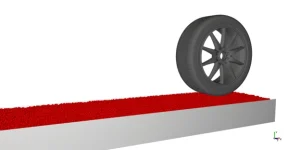 : Wheel above the sand and gravel road initially, displaying the heavy tire waiting to drop onto the loose particle surface